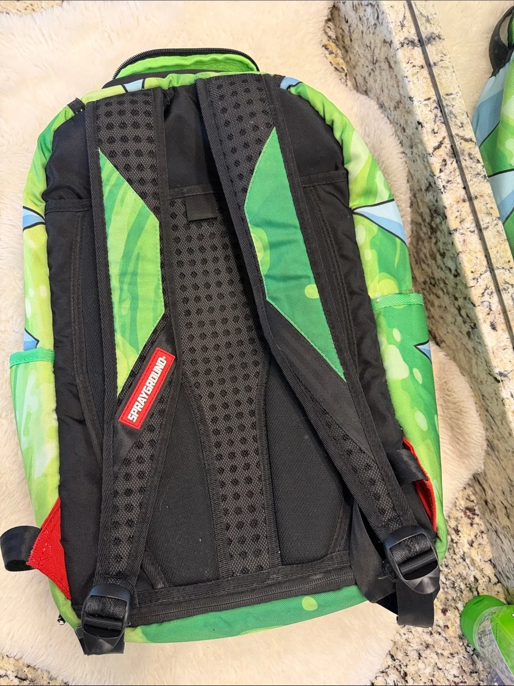 Sprayground Rick Face Backpack in Green, Black, Red, Blue